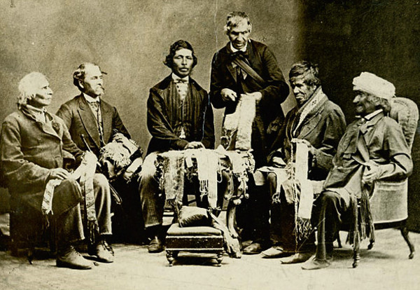 Titre original&nbsp;:    Description English: Chiefs of the Six Nations at Brantford, Canada, explaining their wampum belts to Horatio Hale September 14, 1871. Image shows Joseph Snow (Hahriron), Onondaga Chief;George H. M. Johnson (Deyonhehgon), Mohawk chief, Government interpreter and son of John Smoke Johnson; John Buck (Skanawatih), Onondaga chief, hereditary keeper of the wampum; John Smoke Johnson (Sakayenkwaraton), Mohawk chief, speaker of the council; Isaac Hill (Kawenenseronton), Onondaga chief, fire keeper; John Seneca Johnson (Kanonkeredawih), Seneca chief. Hale inscribed these photographs, which he sent to colleagues, "The wampum belts were explained to me on the reserve, at the residence of Chief G. H. M. Johnson; and at my request the chiefs afterwards came with me to Brantford, where the original photograph . . . was taken.--H. Hale, Clinton, Ont." This copy of the photographs was one tha